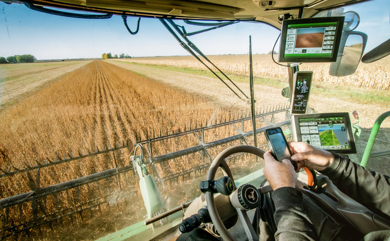 a-man-driving-a-tractor-through-a-wheat-field