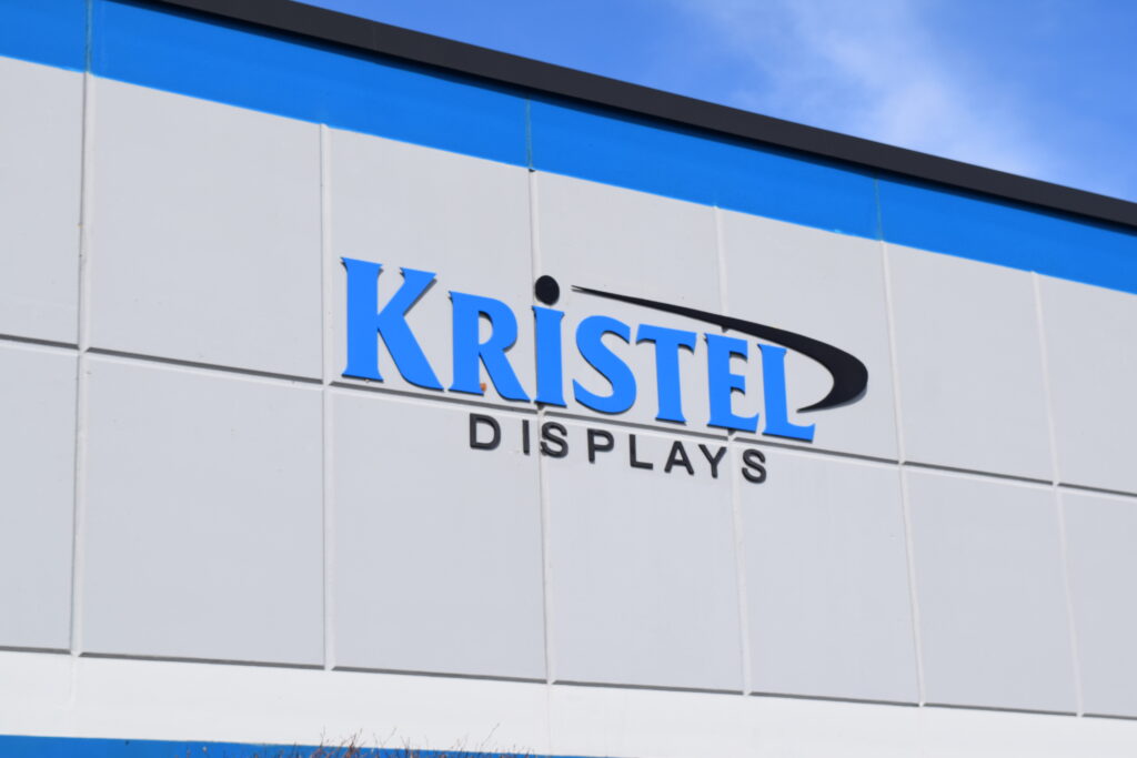 a-sign-for-kristel-displays-on-the-side-of-a-building